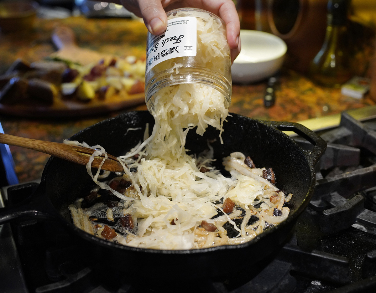 Cook adds Morses sauerkraut to a pan.