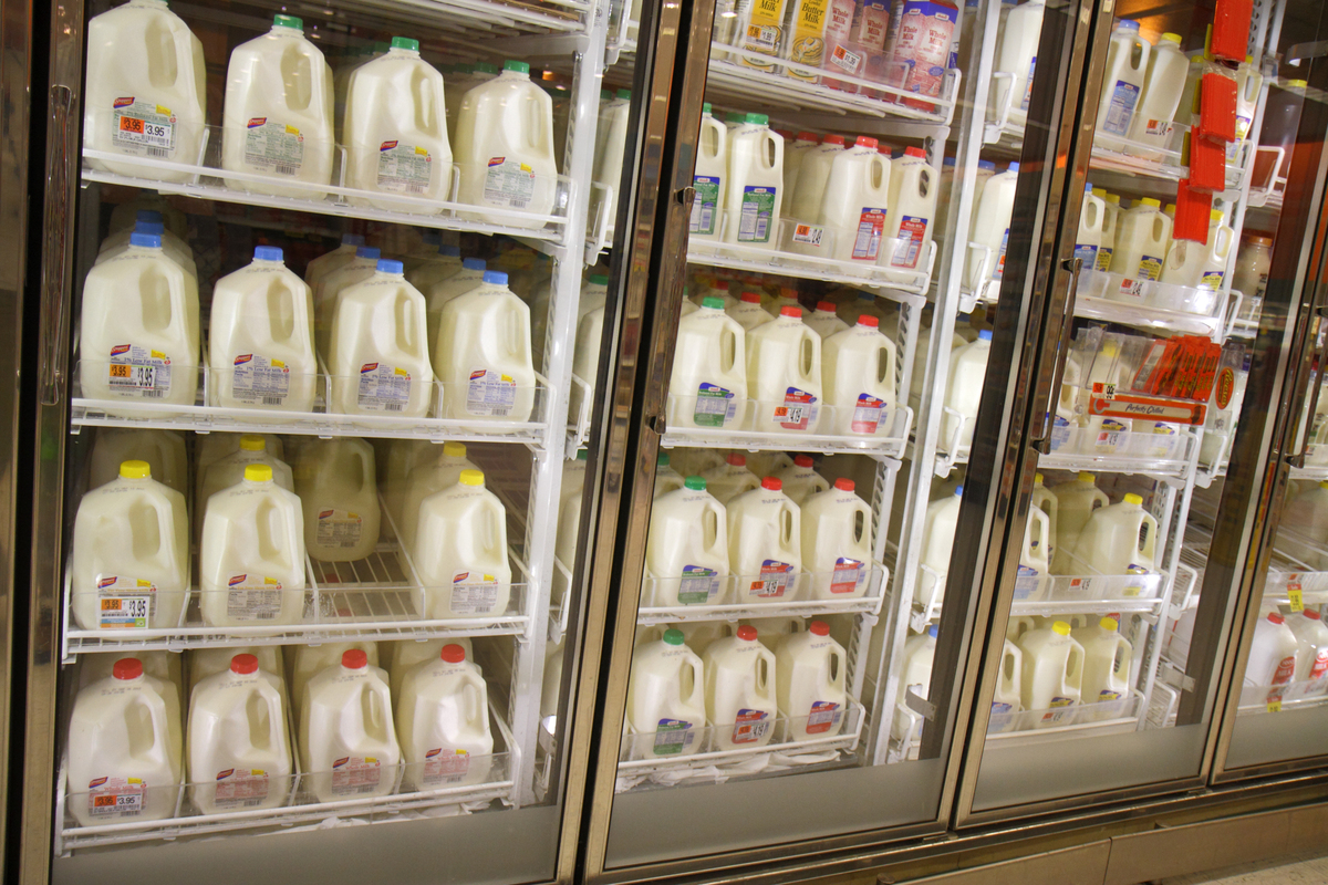 Dairy products are on shelves inside of a refrigerator in Shaw's grocery store.
