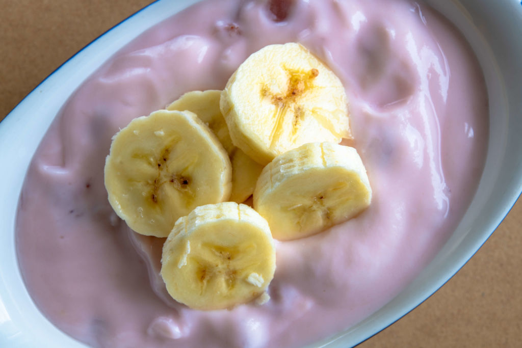 banana slices on top of strawberry yogurt