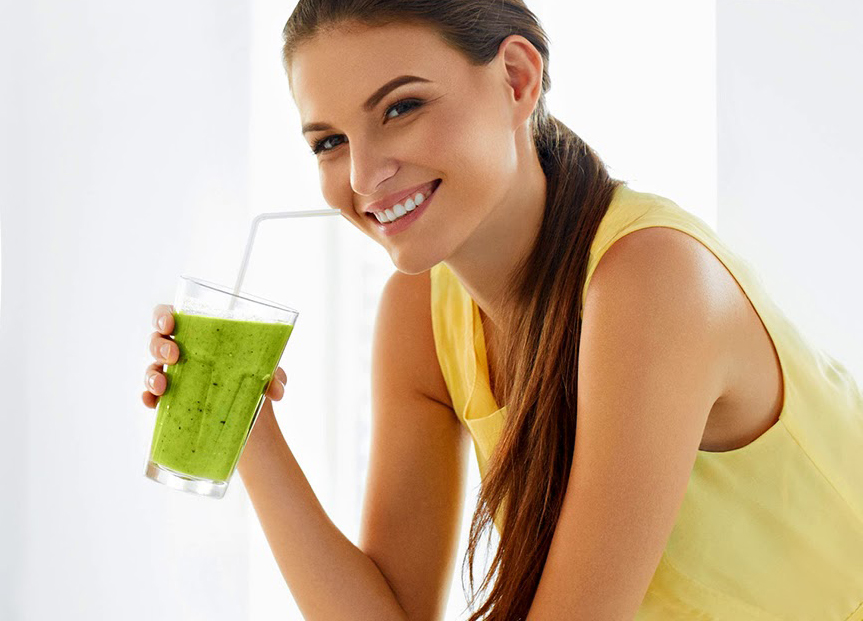 Woman drinks a blend of barley grass powder.