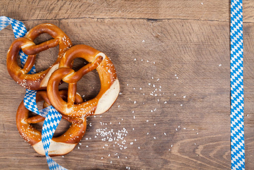 3 pretzels on a wooden table with some ribbon